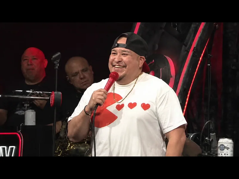 Sancho smiling on the Kill Tony stage