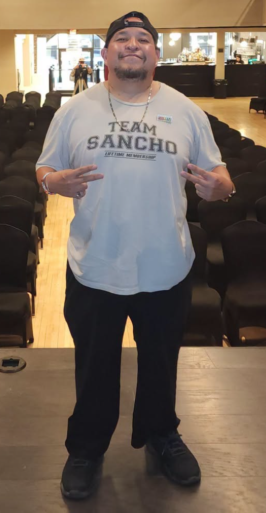 Sancho Villa in his Team Sancho shirt, making peace signs with both hands
